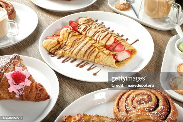 group of fresh coffee shop sweet food dishes on wooden table - fancy breakfast buffet stock pictures, royalty-free photos & images