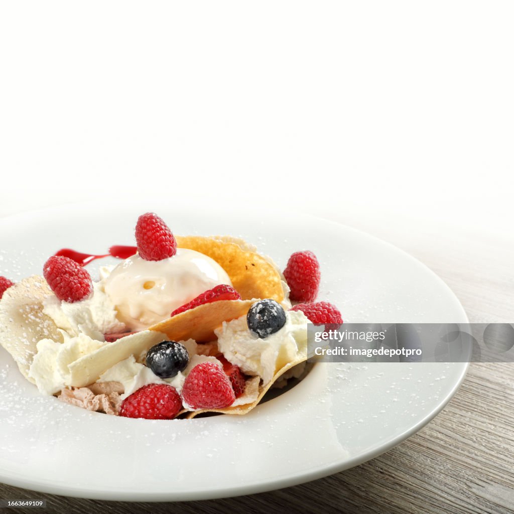 Dessert with mix berry fruits and cream