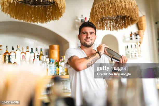 male bartender mixing cocktail in shaker - bloody mary stock pictures, royalty-free photos & images