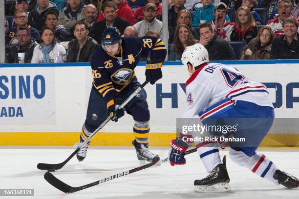 Davis Drewiske of the Montreal Canadiens tries to block the shot of Thomas Vanek of the Buffalo Sabres during the NHL game at First Niagara Center on...