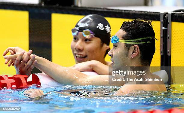 Kosuke Kitajima and Akihiro Yamaguchi shake hands after competing in the Men's 100m Breaststroke final during day one of the Japan Swim 2013 at Daiei...