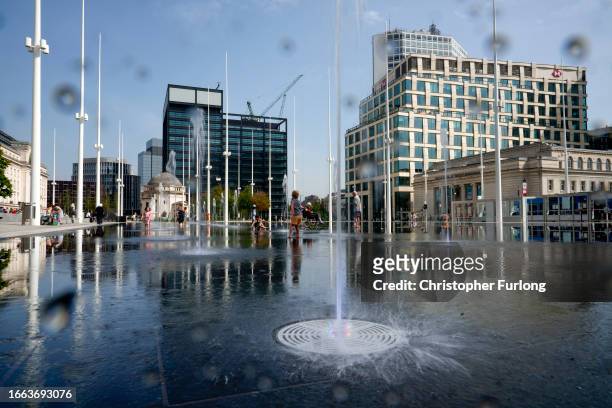 Children play in the fountains of Centenary Square after the city council declared its financial challenge on September 06, 2023 in Birmingham,...