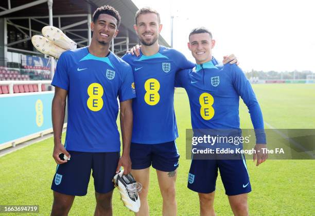 Jude Bellingham, Jordan Henderson and Phil Foden of England pose for a photo during a training session at St George's Park on September 06, 2023 in...