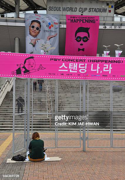 Fan of South Korean rapper Psy waits outside a closed venue hours before the start of a concert by the "Gangnam Style" star at the World Cup Stadium...