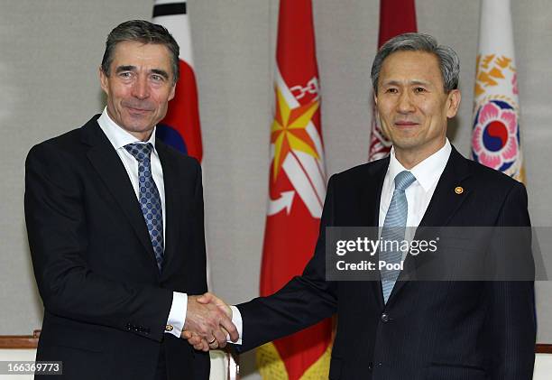 Anders Fogh Rasmussen , the NATO Secretary General, shakes hands with South Korean Defense Minister Kim Kwan-Jin at the defense ministry on April 12,...