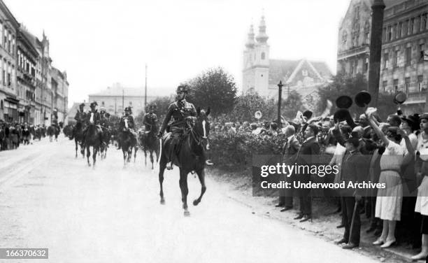 Major Ostenburg leads a detachment of gendarmes through Sopron in support of the West-Hungarians who are protesting the Trianon Treaty which would...