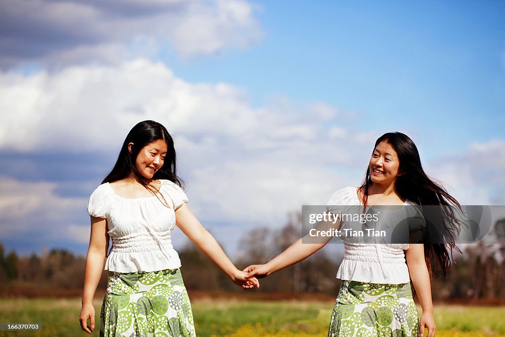 Girl hand in hand in the sun