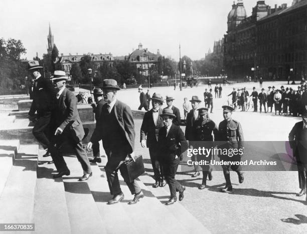 Detective Inspector Collins of Scotland Yard bringing to the court British witnesses who testified to crimes and atrocities commited by the Germans...