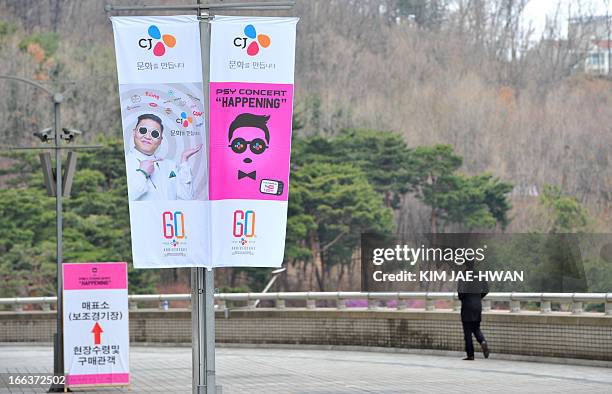 Banners advertising a concert by South Korean rapper Psy are displayed outside the World Cup Stadium in Seoul on April 12 a day before the "Gangnam...