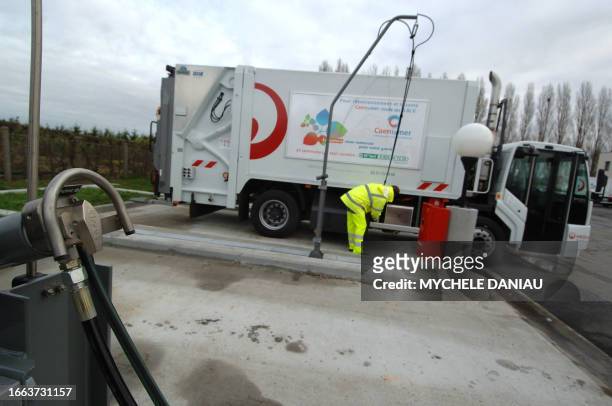 An employee of Veolia Proprete, the Environmental services' division of Veolia, European leading waste management provider, fills a waste truck 13...