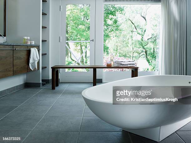 free standing bathtub in corian - tile flooring stock pictures, royalty-free photos & images