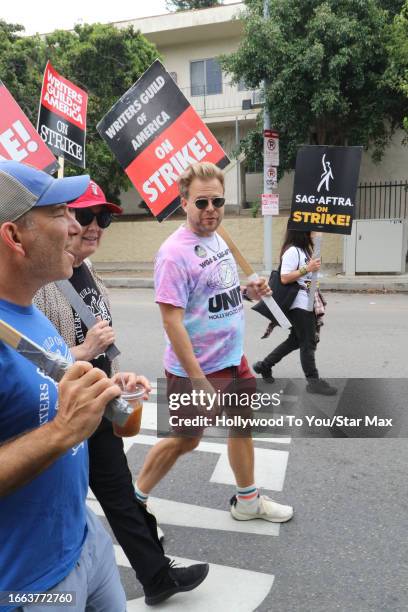 Adam Conover walks the picket line at the SAG-AFTRA and WGA strike on September 13, 2023 at Paramount Studios in Hollywood, California.