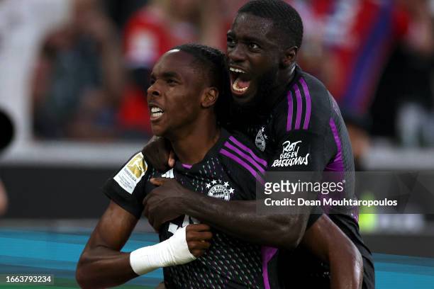 Mathys Tel of Bayern Munich celebrates with teammate Dayot Upamecano after scoring the team's second goal during the Bundesliga match between...