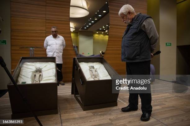 Mexican journalist and UFO expert, Jaime Maussan observes the 'non-human' beings before a press conference, at the Camino Real hotel, in Mexico City,...