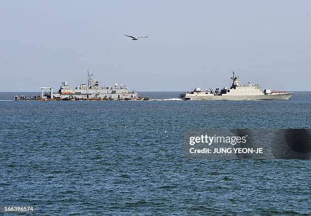 South Korean Navy vessel sails by Navy MSB off the South Korea-controlled island of Yeonpyeong near the disputed waters of the Yellow Sea on April...