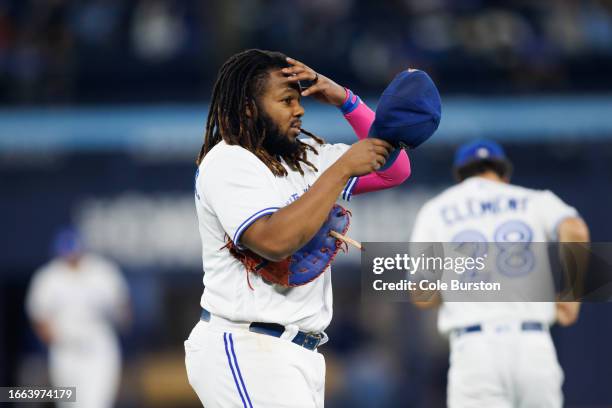 Vladimir Guerrero Jr. #27 of the Toronto Blue Jays puts on his hat after hitting a pop fly to end the sixth inning of their MLB game against the...