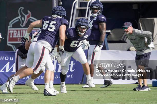 Houston Texans guard Tyler Beach and center Jarrett Patterson run a blocking drill during an NFL training camp Monday, Aug. 14 in Houston.