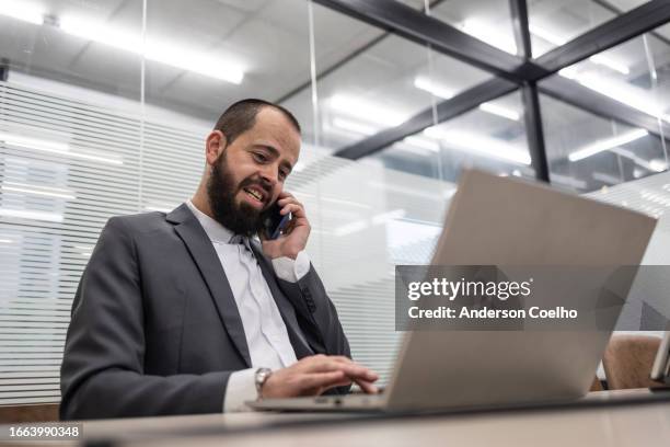 jewish man working in office with notebook and phone - modern judaism stock pictures, royalty-free photos & images