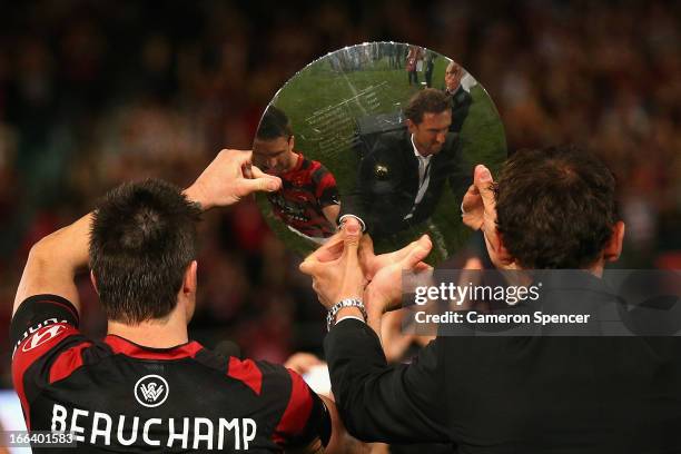 Wanderers coach Tony Popovic and captain Michael Beauchamp hold the Premiers' Plate aloft after winning the A-League Semi Final match between the...