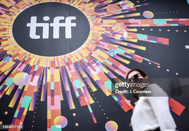 Woman walks past a large TIFF advertisement at the TIFF Bell Lightbox on September 06, 2023 in Toronto, Ontario.