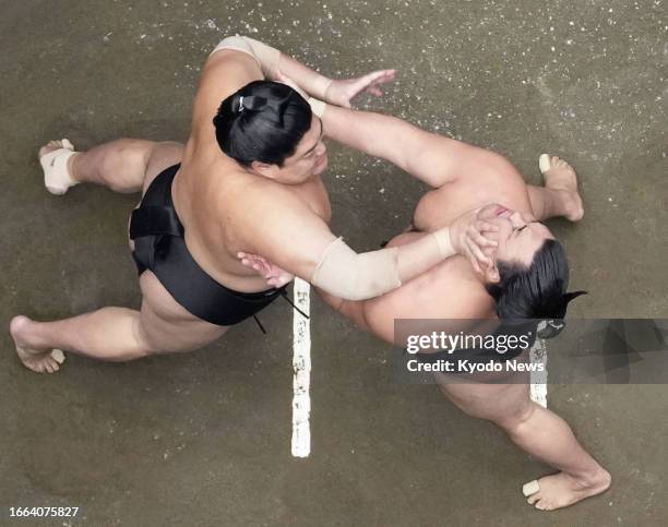 Photo captured by a ceiling camera shows rank-and-file wrestler Abi giving ozeki Kirishima shoves to the face during their bout on Day 4 of the...