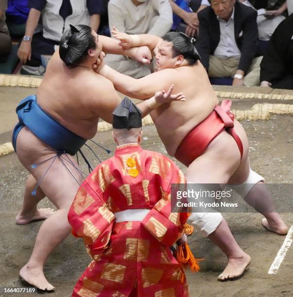 Shonannoumi grapples with fellow rank-and-filer Onosho during their bout on Day 4 of the Autumn Grand Sumo Tournament at Ryogoku Kokugikan in Tokyo...
