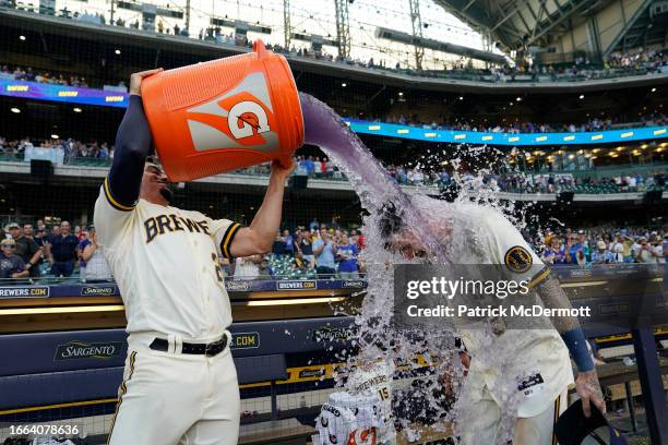 Willy Adames of the Milwaukee Brewers pours Gatorade on Brice Turang after he hit a walk-off RBI single in the 10th inning against the Minnesota...