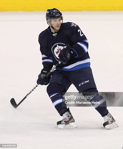 Aaron Gagnon of the Winnipeg Jets keeps his eye on the play during third period action in a game against the Buffalo Sabres on April 9, 2013 at the...