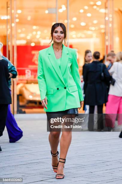 Jana Azizi, wearing a green blazer by Mar Cain and a black skirt by Marc Cain, during a streetstyle shooting at the Breuninger Anniversary...