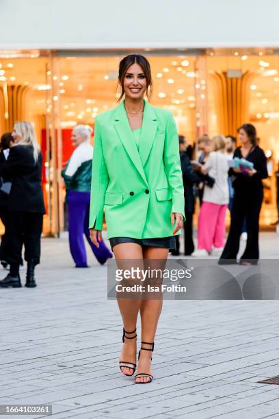 Jana Azizi, wearing a green blazer by Mar Cain and a black skirt by Marc Cain, during a streetstyle shooting at the Breuninger Anniversary...
