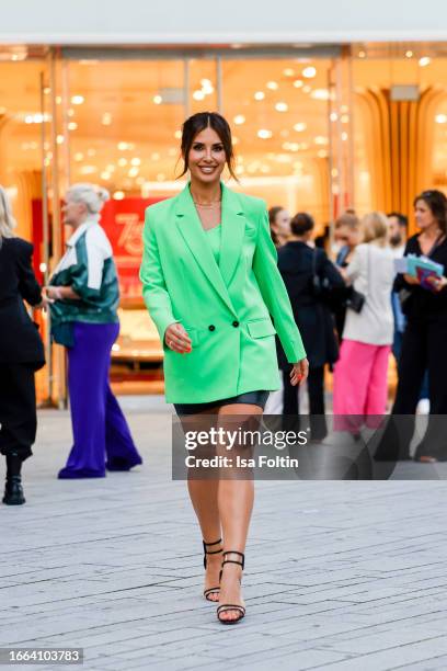 Jana Azizi, wearing a green blazer by Mar Cain and a black skirt by Marc Cain, during a streetstyle shooting at the Breuninger Anniversary...