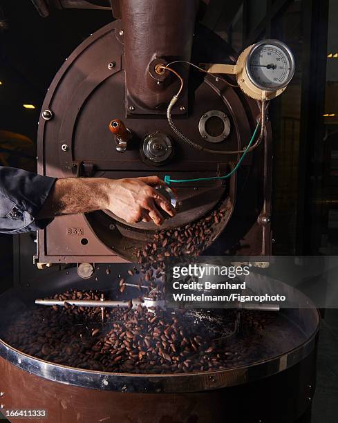 Figaro ID: 106545-013. Cocoa beans are photographed being crushed at Chef Alain Ducasse and pastry chef Nicolas Berger's chocolate store for Madame...