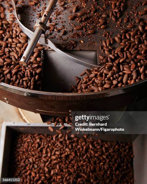 Figaro ID: 106545-018. Cocoa beans are photographed being crushed at Chef Alain Ducasse and pastry chef Nicolas Berger's chocolate store for Madame...