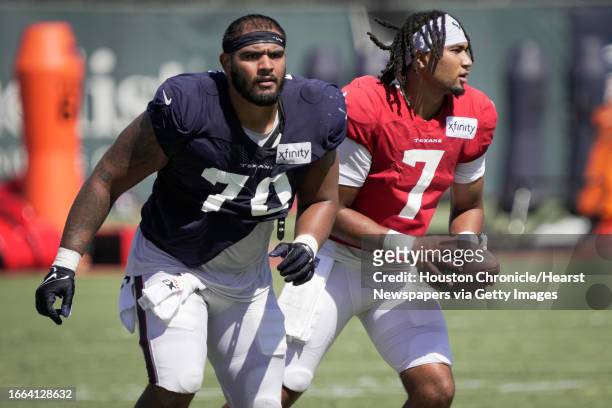 Houston Texans center Juice Scruggs and quarterback C.J. Stroud work extra after practice during an NFL training camp Wednesday, Aug. 16 in Houston.