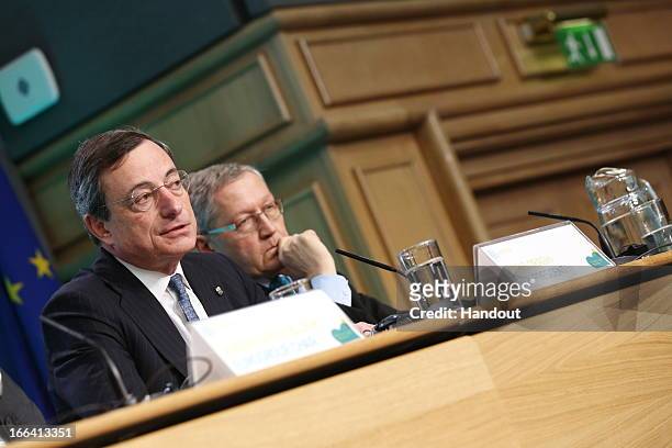 Mario Draghi, President ECB, speaks as and Klaus Regling, managing director EFSF/ESM, looks on at a press conference following the Eurogroup meeting...