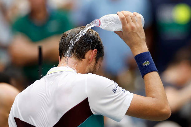 Daniil Medvedev pours water over his head to cool down after winning his match against Andrey Rublev during their Men's Singles Quarterfinal match on...