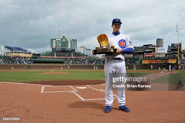 Second baseman Darwin Barney of the Chicago Cubs holds his 2012 Golden Glove Award at Wrigley Field on April 12, 2013 in Chicago, Illinois. Barney...