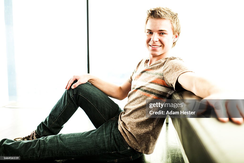 Portrait of a young man inside of a modern studio.