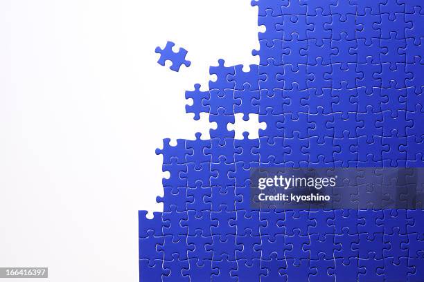 isolated shot of blue jigsaw puzzle on white background - connect the dots puzzle stock pictures, royalty-free photos & images