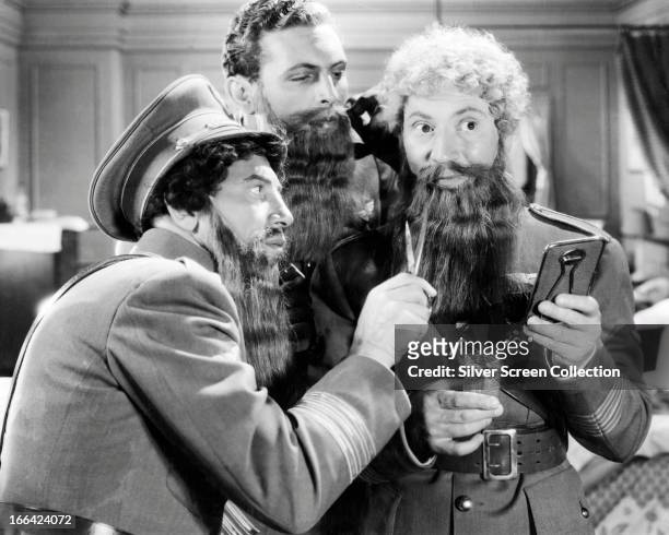 Left to right; Chico Marx , Allan Jones and Harpo Marx disguise themselves with stolen beards in a scene from the Marx Brothers' comedy 'A Night At...