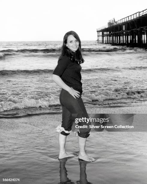American actress Susan Strasberg walking on a beach, circa 1970.