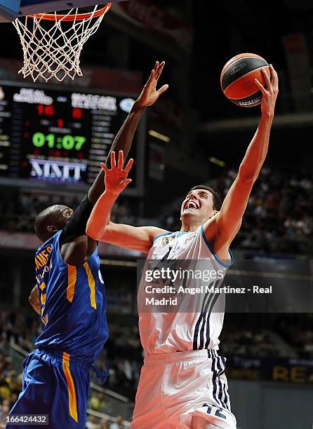 Nikola Mirotic of Real Madrid aims to shoot over Shawn James of Maccabi Electra Tel Aviv during the Turkish Airlines Euroleague Play Off game 2 at...