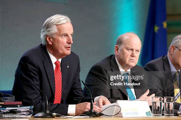 Michel Barnier, Commisioner for Internal Market and Services, and Minister for Finance Michael Noonan attend a press conference following the...