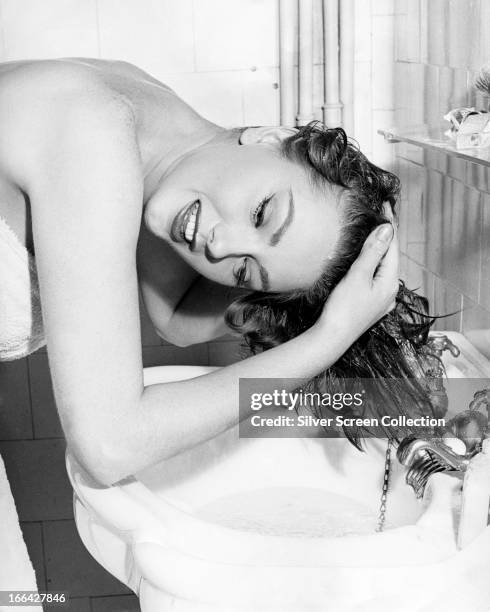 Italian actress Sylva Koscina washing her hair, circa 1960.