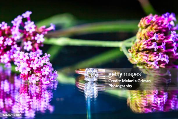 diamond ring and purple flowers - solitaire stock pictures, royalty-free photos & images