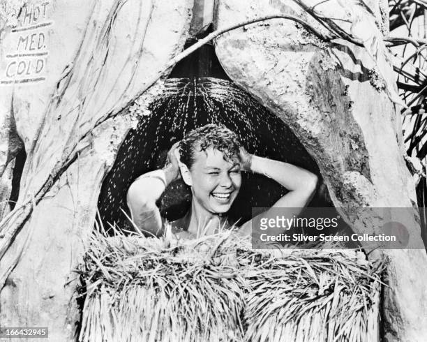 Ensign Nellie Forbush, played by American actress and singer Mitzi Gaynor, takes a shower in the musical 'South Pacific', directed by Joshua Logan,...