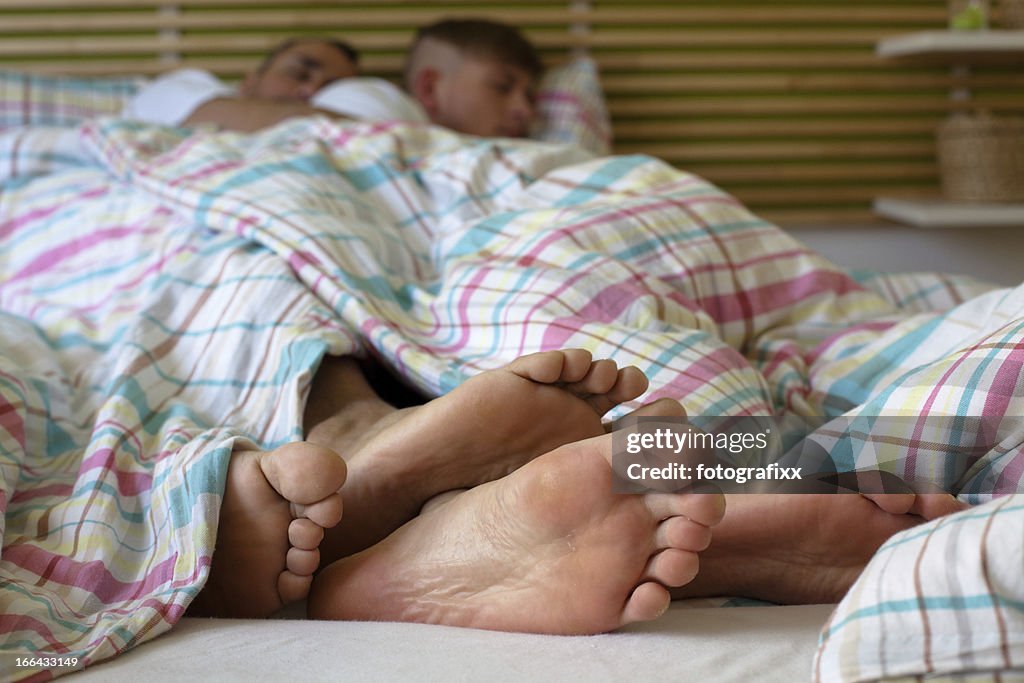 Feet from two gay man sleeping, focus on foreground