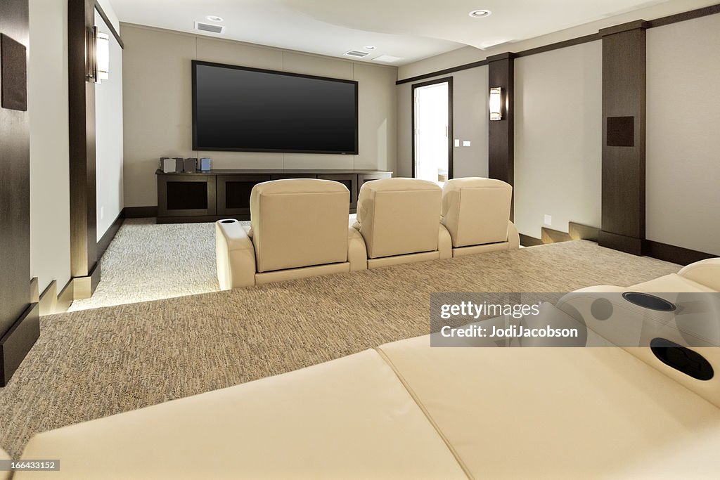 Two room home theatre with large flat screen tv.