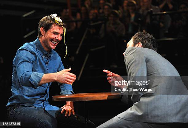 Tom Cruise and Jimmy Fallon play "Egg Roulette" during a taping of "Late Night With Jimmy Fallon" at Rockefeller Center on April 12, 2013 in New York...