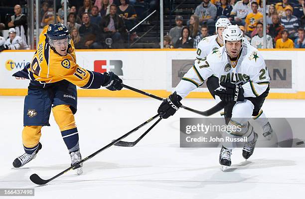 Bobby Butler of the Nashville Predators fires a shot against Aaron Rome of the Dallas Stars during an NHL game at the Bridgestone Arena on April 12,...